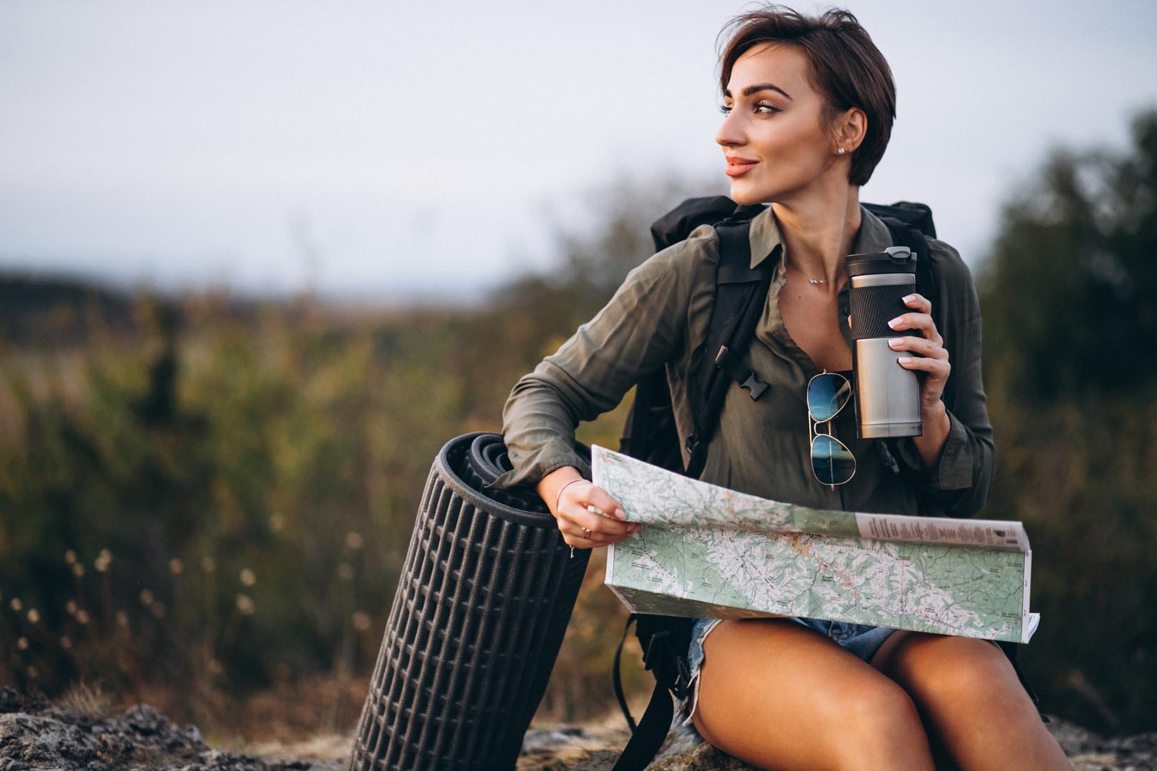 Woman mountain with travel bag looking map